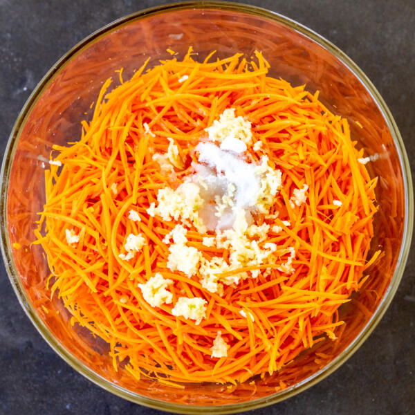 Carrots, sugar, salt and vinegar in a bowl.