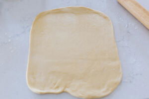 Rolle out dough on a counter.