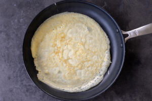 Crepe cooking in a pan.