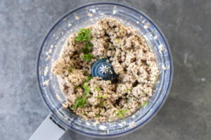 Blended meat with herbs in a food processor.