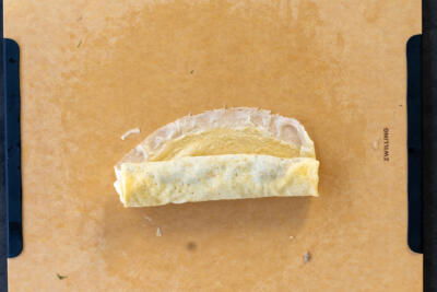 Crepe rolled up with meat filling.