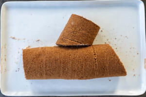 Sliced cake roll into a log.