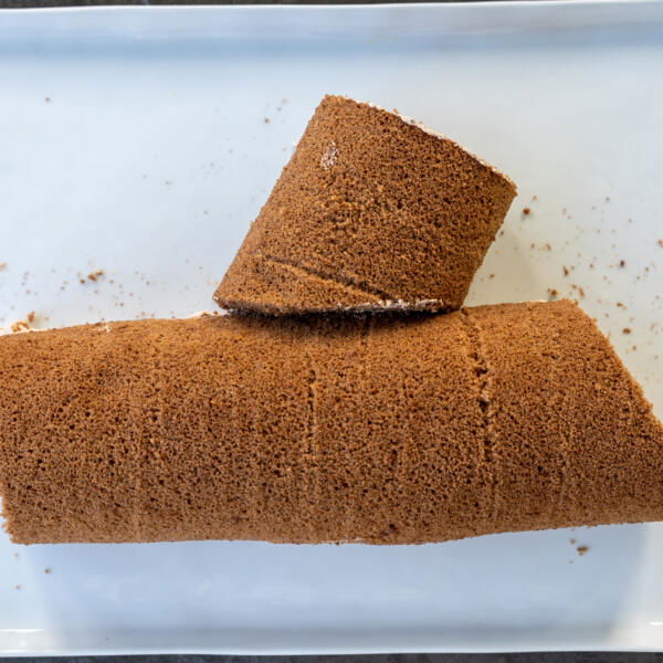 Sliced cake roll into a log.