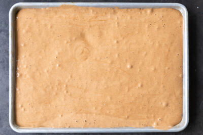 Chocolate cake batter in a sheet pan.
