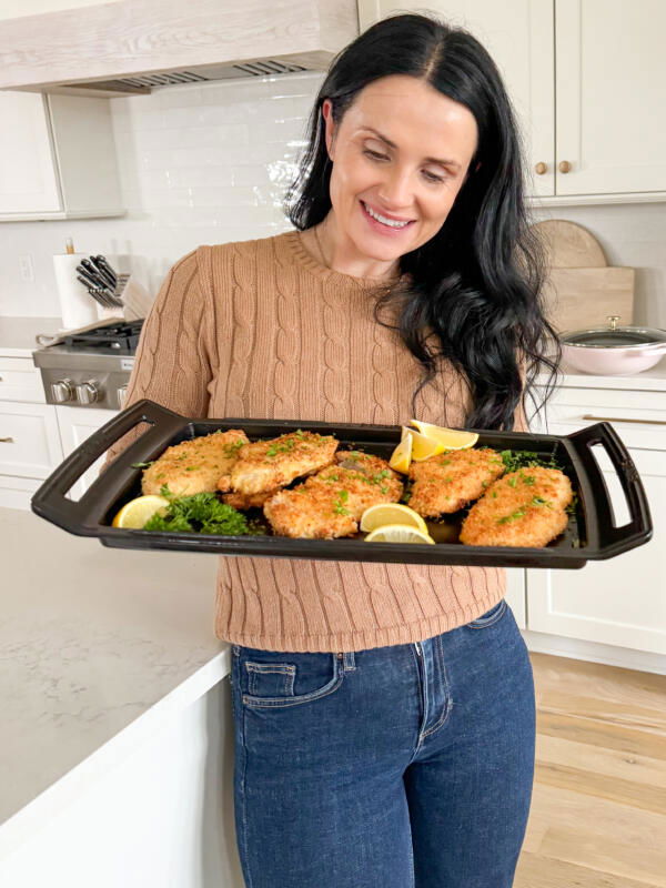 Natalya with Baked Chicken Cutlets on a serving tray.