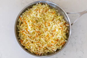 Cabbage added to the carrot and onion.