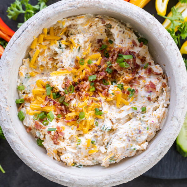 Crack Dip on a tray with veggies around.