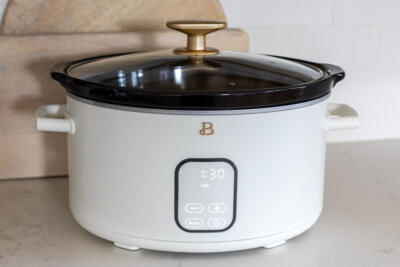 Crock pot set on low on a counter.