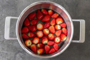 Strawberries with water in a pot.