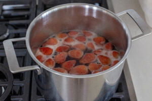 Strawberries boiling in a pot.