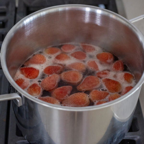 Strawberries boiling in a pot.