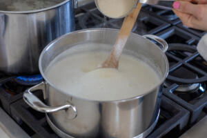 Porridge added to the milk in a pot.