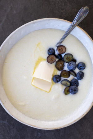 Semolina Porridge in a bowl with berried and butter.