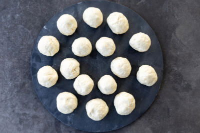Dough pieces rolled up into a ball.