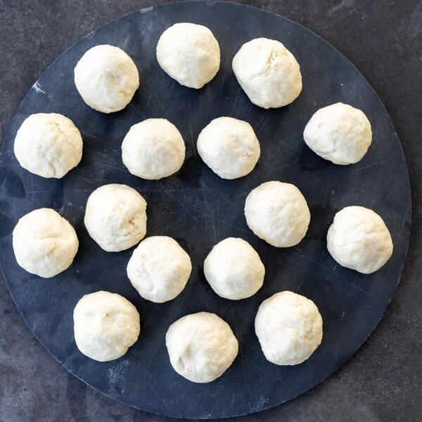 Dough pieces rolled up into a ball.