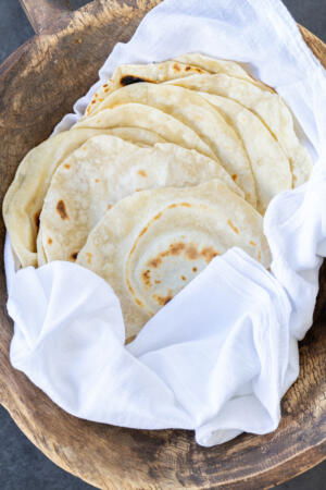Sourdough Flour Tortillas in a towel.