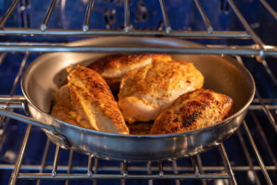 Stuffed chicken in a pan baking.