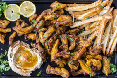 Serving tray with Air Fryer Chicken Shawarma, fries and hummus.