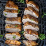 Sliced up duck breast in air fryer basket.