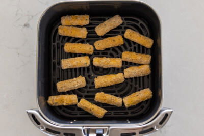 Air Fryer Mozzarella Sticks in a basket.