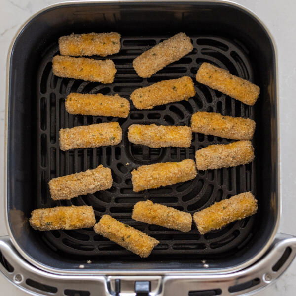 Air Fryer Mozzarella Sticks in a basket.