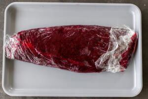 Salmon wrapped into beet mixture.