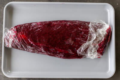 Salmon wrapped into beet mixture.