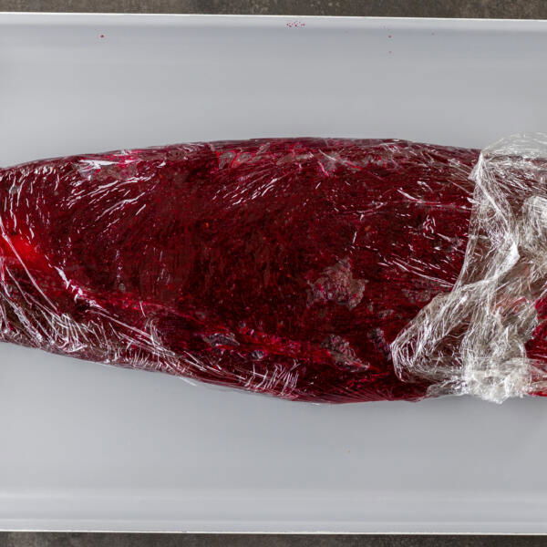 Salmon wrapped into beet mixture.