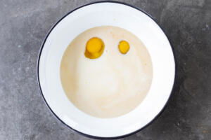 Eggs and liquids in a bowl.