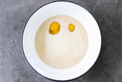 Eggs and liquids in a bowl.