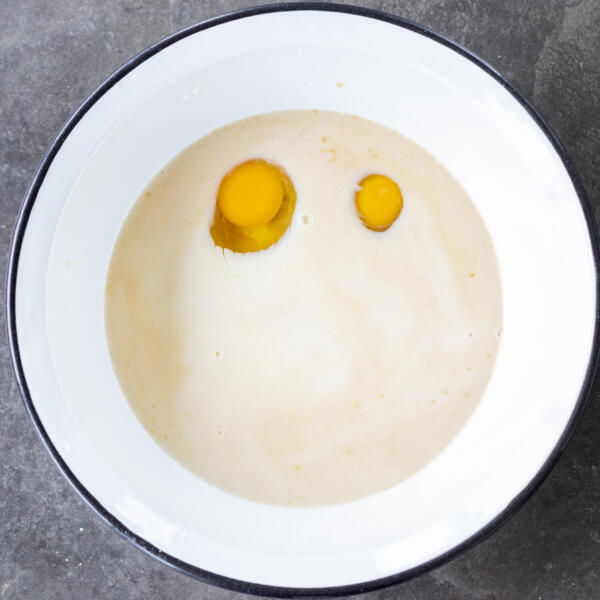 Eggs and liquids in a bowl.