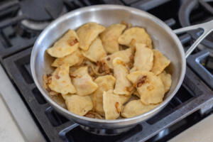 Pan with varenyky and onion.