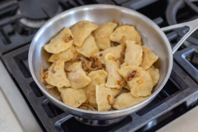 Pan with varenyky and onion.
