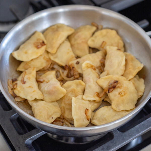 Pan with varenyky and onion.