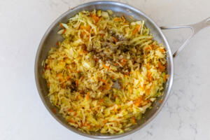 Seasoning added to the cabbage in the pan.