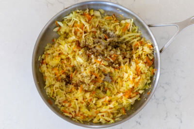 Seasoning added to the cabbage in the pan.