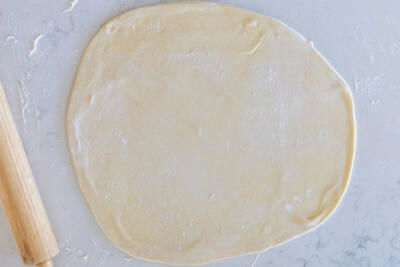 Rolled out dough on a floured surface.