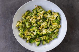 Broccoli with dressing in a bowl.