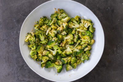 Broccoli with dressing in a bowl.
