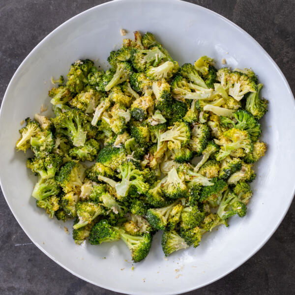 Broccoli with dressing in a bowl.