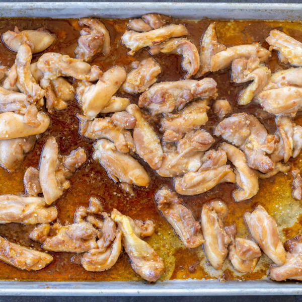 Baked chicken on a pan.