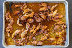 Browned chicken on a sheet pan.