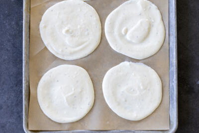 Lined baking sheet with parchment paper and cottage cheese flatbread batter.