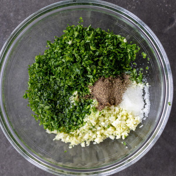 parsley, galic, oil, lemon, salt and pepper in a bowl.