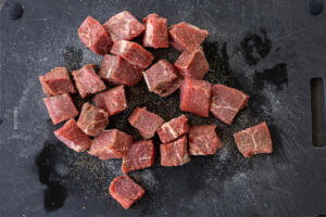 Sliced steak with salt and pepper.