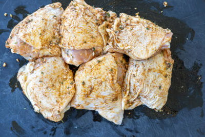 Seasoned chicken on a tray.