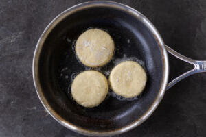 Pan with oil and Syrniki.