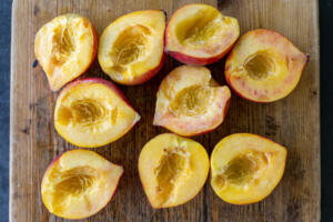 Sliced peaches on a cutting board.