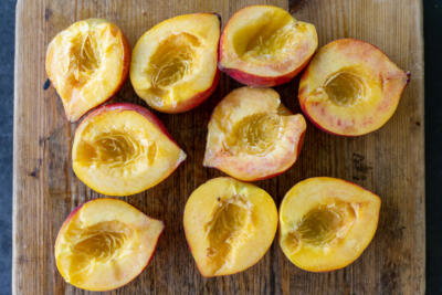 Sliced peaches on a cutting board.