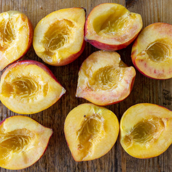 Sliced peaches on a cutting board.